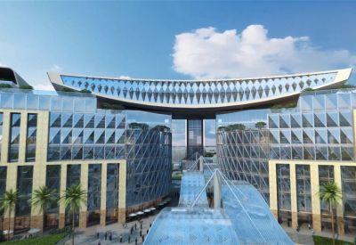 Close-up view of the modern glass facade and distinctive curved roof structure.
