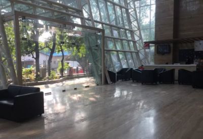 Bright lobby area with glass walls and lounge seating.