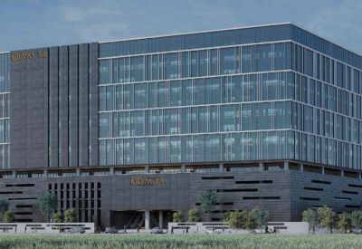 Exterior view of the modern glass-facade building at Redbrick Offices, Olympia Cyberspace.