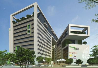 Exterior view of the modern multi-story Redbrick Offices, Thane One building with green accents and landscaped trees.