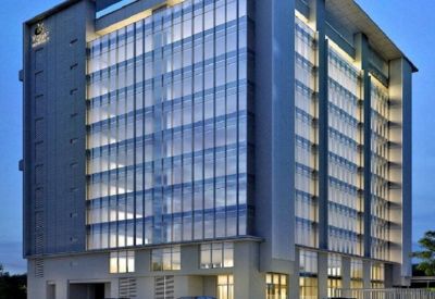 Modern glass-facade building with evening lighting.