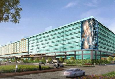 Exterior view of the modern glass facade at Redbrick Offices, Prestige Trade Center.