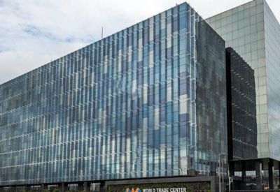 Large glass-fronted office building with a blue and grey paneled facade.