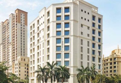 High-rise building with palm trees in the foreground.