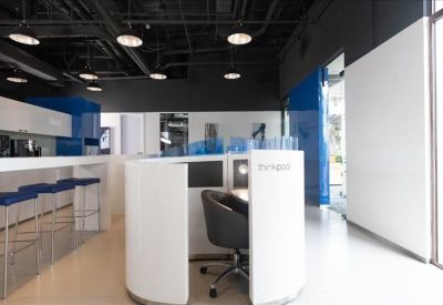 Coworking area featuring a private semi-enclosed workstation and breakfast bar.