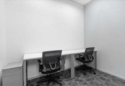 Private office space with a double workstation and grey filing cabinet.