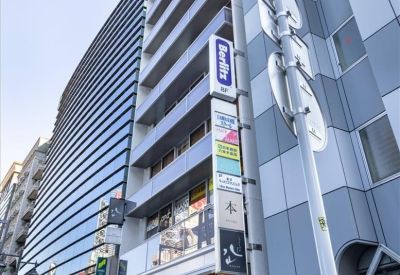 Exterior view of the contemporary facade and street-level entrance of the Roppongi Denki Building.