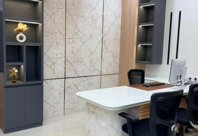 Private office with a marble-patterned feature wall and a modern white desk.