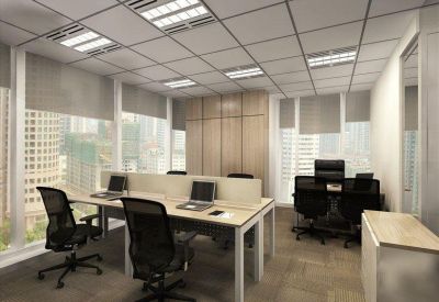 Conference room with long table, black mesh chairs, and geometric window patterns.