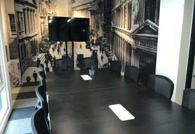 Monochrome boardroom with a large black table and a vintage city street mural.