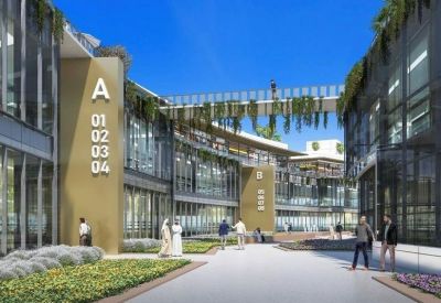Modern walkway between buildings with hanging greenery and signage.