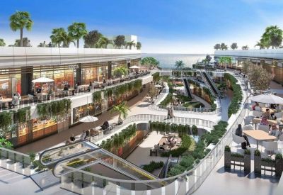 Bright multi-level courtyard with escalators and outdoor seating.