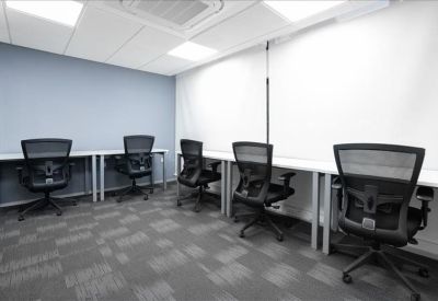Private office suite with five black ergonomic chairs and white workstations.