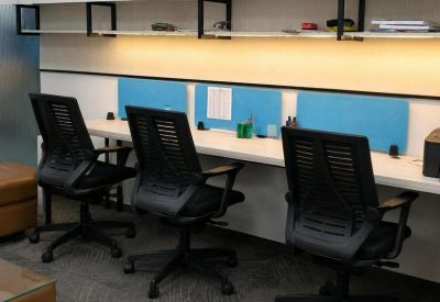 Modern workstation setup with three black mesh chairs, blue privacy dividers, and under-shelf lighting.