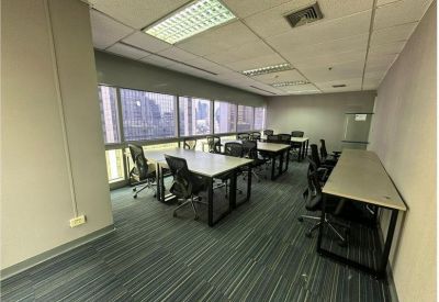 Bright office area with several workstations and a blue-toned striped carpet.