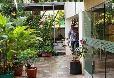 Entrance to Setu, Plot No-69, Bharat Kunj Colony No-2, with a striped awning and lush green plants.