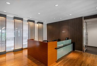 Professional reception area with a wooden front desk and decorative wall panels.