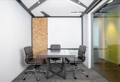 Small meeting room with a wooden feature wall and glass partitioning.
