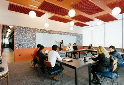 Professional meeting room with a U-shaped table and red acoustic ceiling panels.