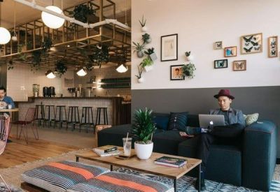 Bright coworking space with a cafe-style bar and comfortable lounge seating.
