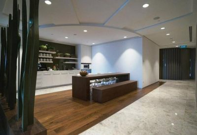 Lounge area featuring a wooden break bar, bench seating, and warm lighting.