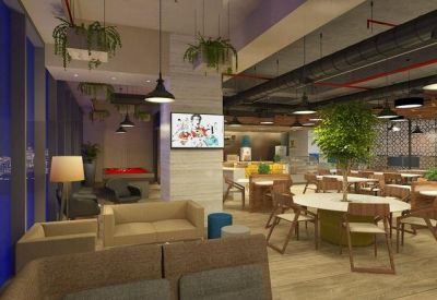Spacious communal lounge with diverse seating, indoor plants, and a pool table.