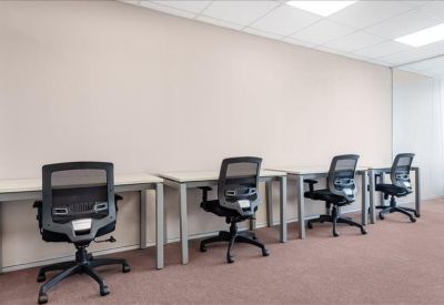 Bright private office suite with four ergonomic workstations.
