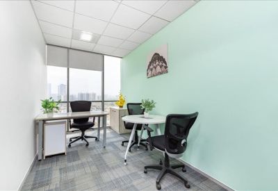 Private office suite with a mint green feature wall and natural light.