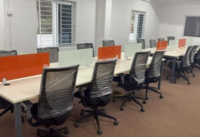 Spacious open-plan workspace with orange privacy dividers at Srinivasam, Vaiyapuri Nagar, Kurumbapalayam.