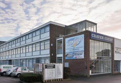 Private window office with two desks and decorative frosted glass.