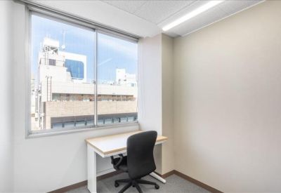 Single workstation with city views through a large window.