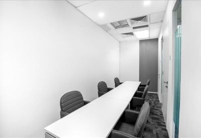 Professional long meeting room with modern seating and carpeted flooring.