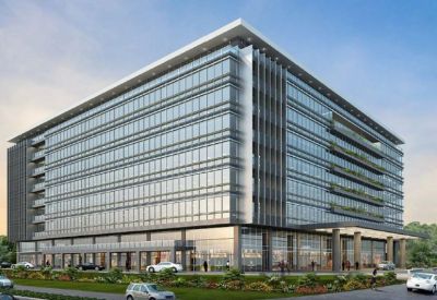 Exterior view of the glass-facade Poloroche Business Avenue with modern architecture and landscaping.