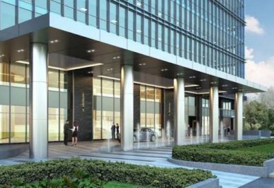Grand building entrance featuring high ceilings, silver pillars, and floor-to-ceiling glass walls.