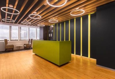 Reception area featuring a lime green desk, wooden slatted ceiling, and a black accent wall with yellow stripes.