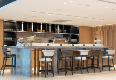 A stylish café and bar area at Taipei 101 Tower with a marble island and high-top seating.