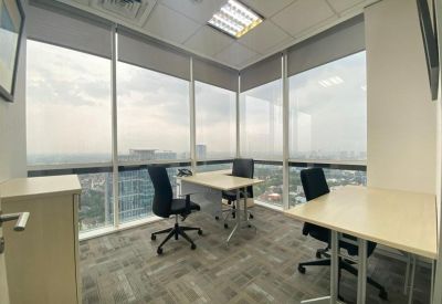 Private office suite with two desks positioned against floor-to-ceiling windows overlooking the city.