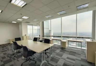 Bright conference room with a long wooden table and panoramic views of the Jakarta skyline.