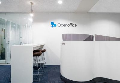 Modern communal area with high stools at a white bar counter and branded wall.