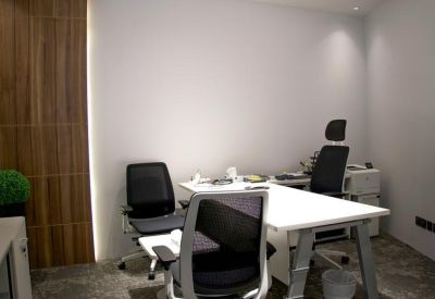 Private two-person office suite with white desks and wooden accent wall.
