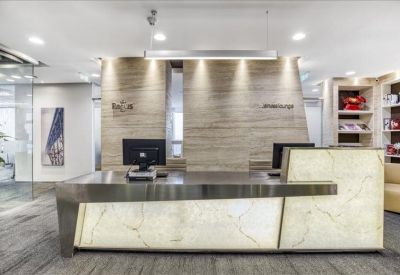 Polished reception desk with marble textures and recessed lighting.