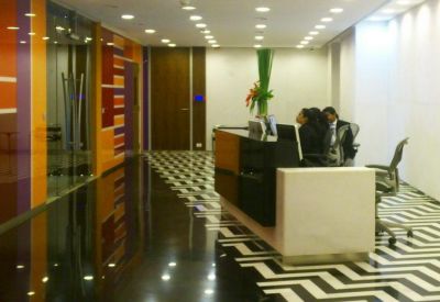 Spacious reception area with a black and white chevron floor and orange feature wall.