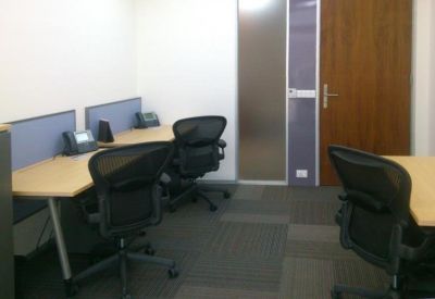 Private office suite with two workstations and ergonomic black mesh chairs.