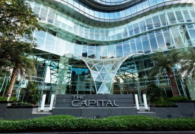 Exterior view of the modern glass facade and sculptural entrance at The Capital.