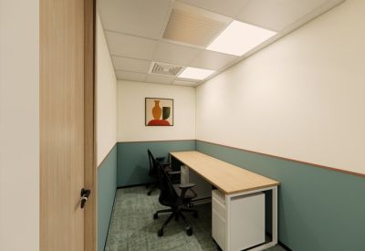 Two-person private office with teal wainscoting and a long wooden desk.
