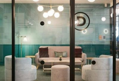 Glass-walled meeting room with plush velvet seating and a modern globe chandelier.