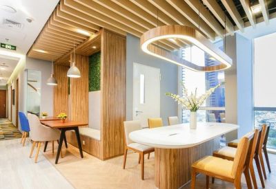 Professional boardroom with black leather chairs and a glass wall with artistic decals.