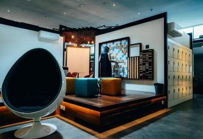 Creative breakout area with a unique egg chair and colorful cube seating.