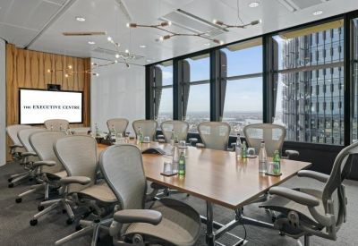 Large boardroom with an elegant wooden table, ergonomic mesh chairs and a view of Three International Towers Sydney.