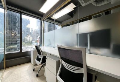 A modern private office at Tower 1, Admiralty Centre with large windows and city views.
